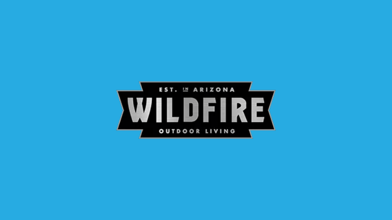 The Wildfire Grills logo on a sky blue background