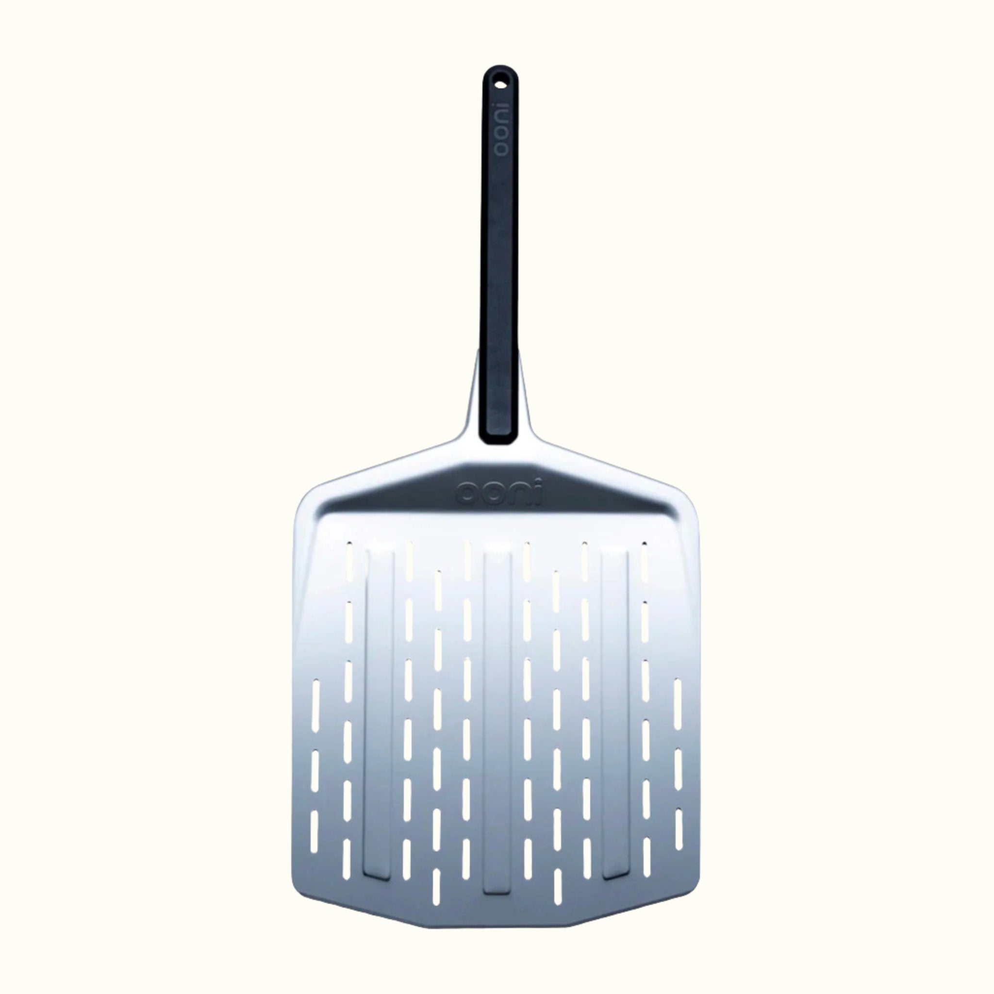 The Ooni 12-Inch Perforated Pizza Peel on an Off-White Background